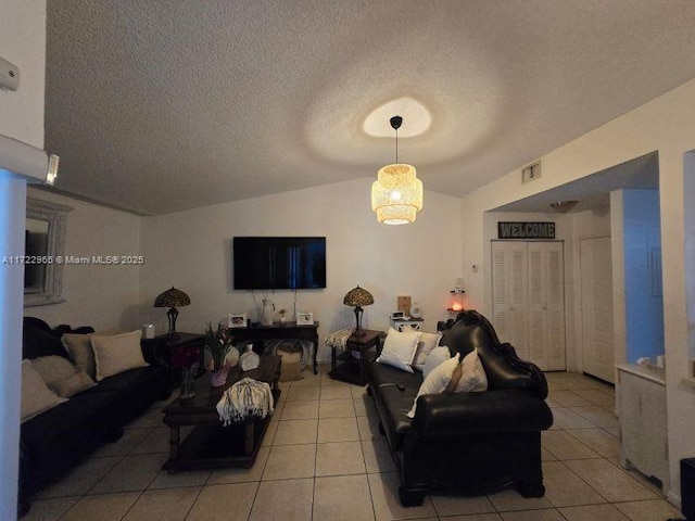 21340 NE 8th Ct Unit 1, Miami, FL 33179 - living room with vaulted ceiling, light tile patterned floors, and a textured ceiling