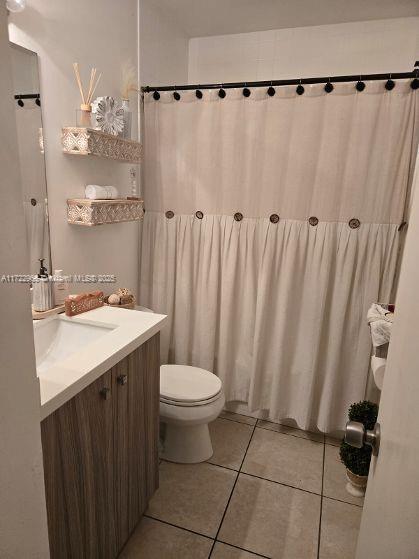 21340 NE 8th Ct Unit 1, Miami, FL 33179 - bathroom with tile patterned floors, toilet, and vanity