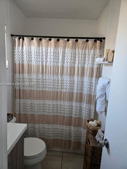 21340 NE 8th Ct Unit 1, Miami, FL 33179 - full bathroom with tile patterned flooring, toilet, and curtained shower
