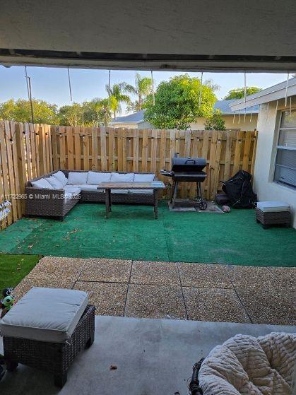 21340 NE 8th Ct Unit 1, Miami, FL 33179 - view of patio featuring an outdoor living space, a fenced backyard, and grilling area