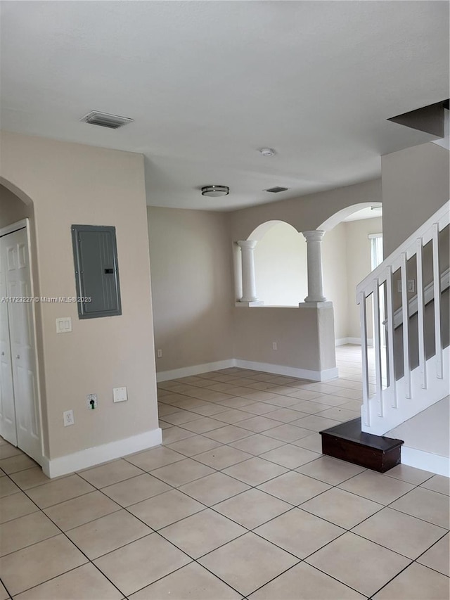 tiled empty room featuring electric panel