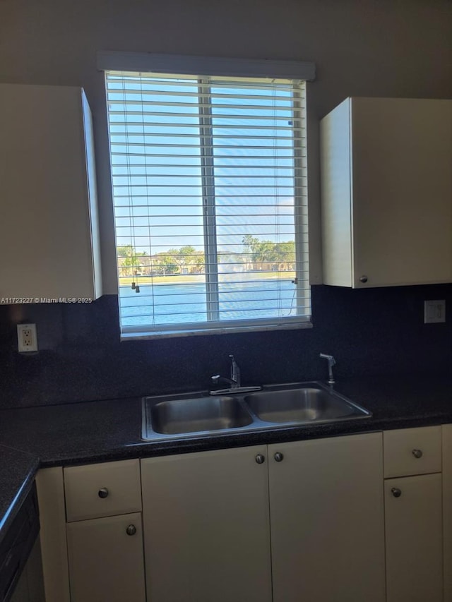 kitchen featuring white cabinets, a healthy amount of sunlight, and sink