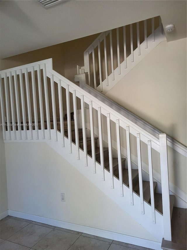 stairs with tile patterned flooring