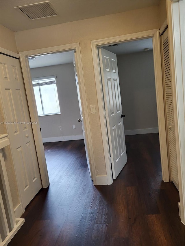 hallway featuring dark hardwood / wood-style flooring