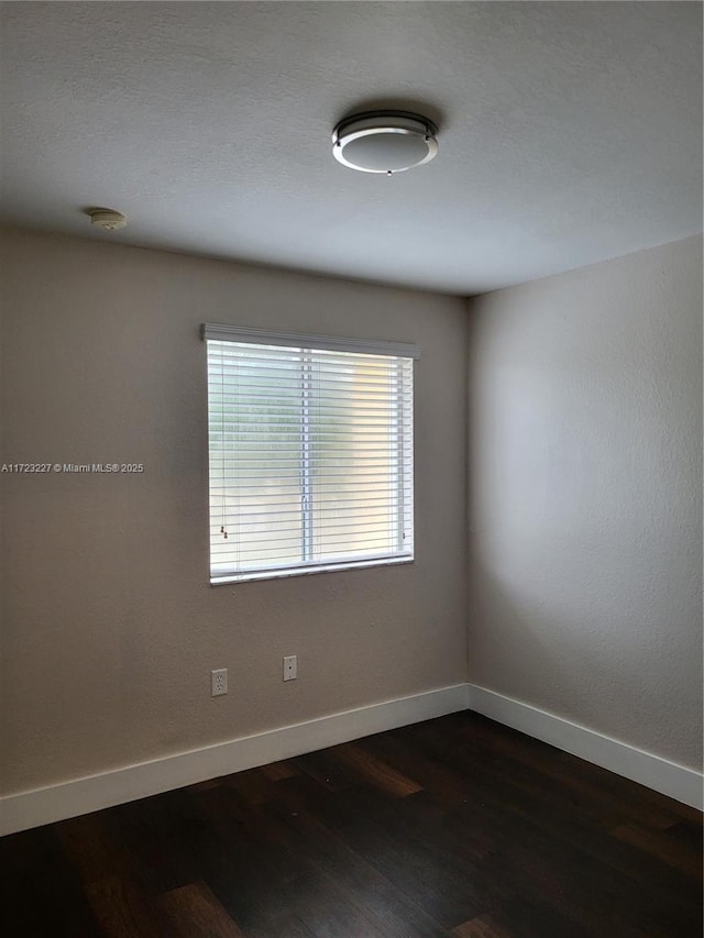 unfurnished room featuring dark hardwood / wood-style floors