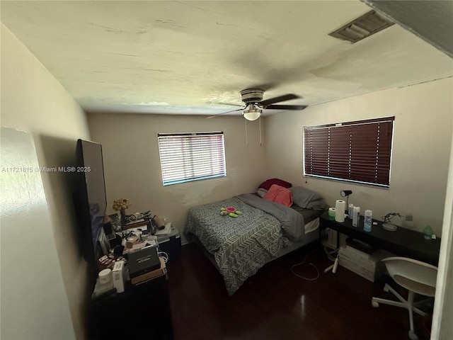 bedroom with ceiling fan and hardwood / wood-style flooring