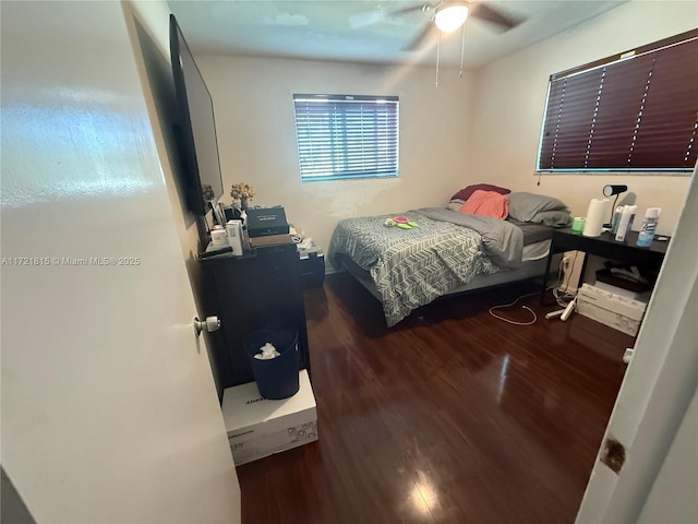 bedroom with ceiling fan and dark hardwood / wood-style floors