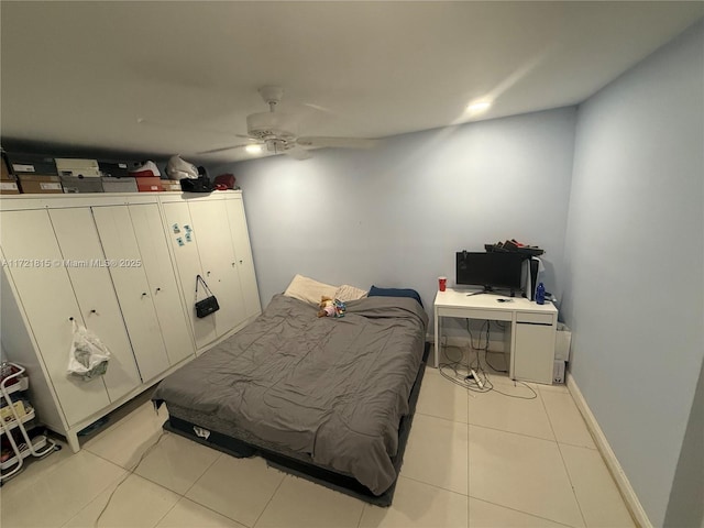 tiled bedroom with ceiling fan