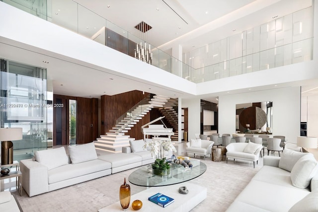 living room with a towering ceiling and wooden walls