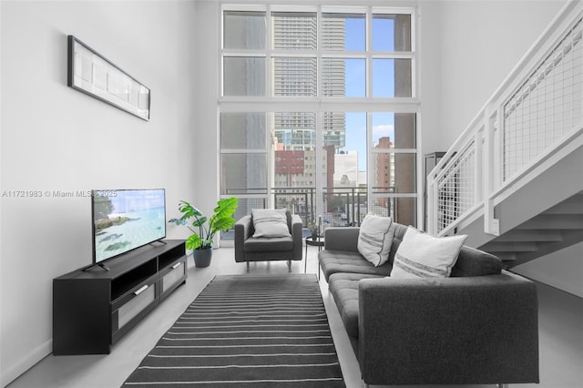 living room featuring a towering ceiling