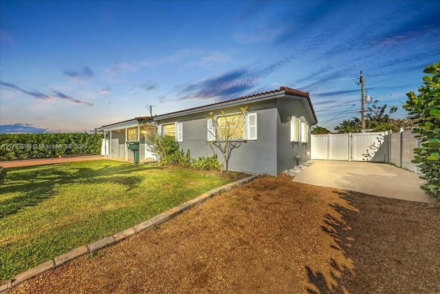 view of front facade with a front lawn and a patio