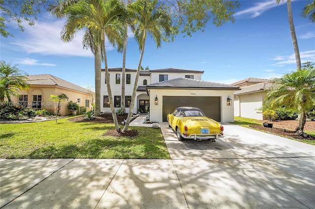 mediterranean / spanish-style house with a front yard and a garage