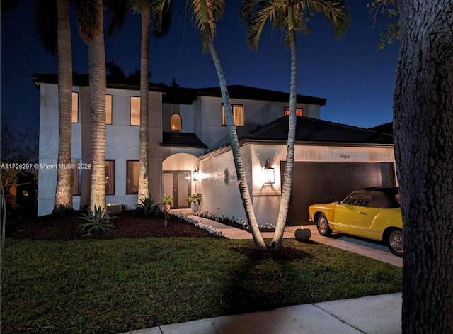 view of front of home featuring a yard and a garage