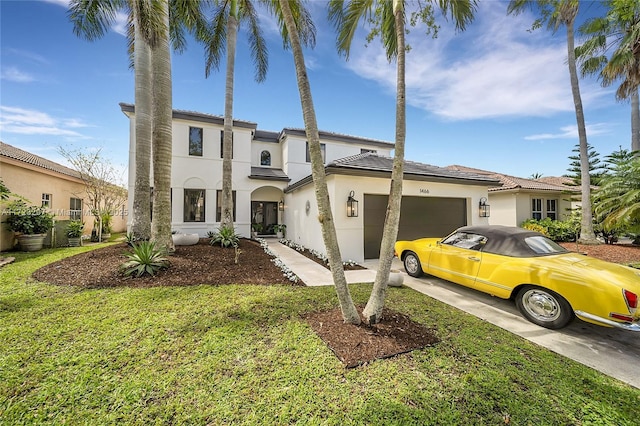 mediterranean / spanish home with a front lawn and a garage