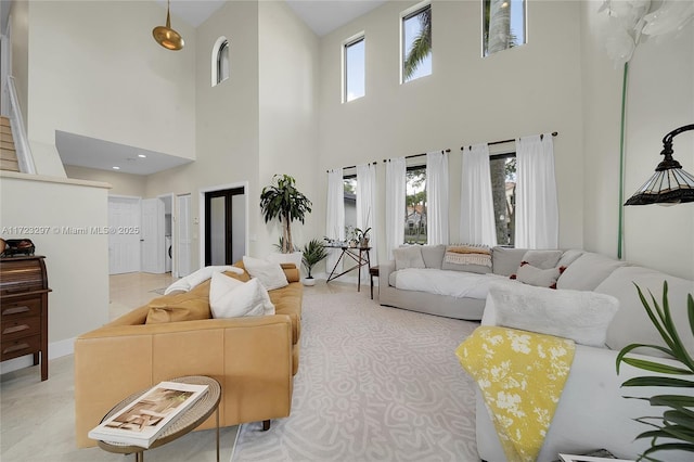 living room featuring a towering ceiling