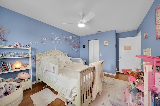 bedroom with ceiling fan, a closet, and dark hardwood / wood-style floors