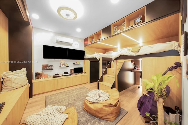 interior space with light hardwood / wood-style flooring and a wall mounted air conditioner