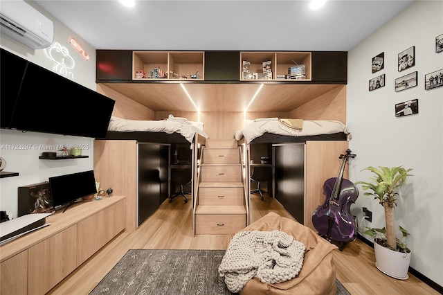 interior space featuring light wood-type flooring and a wall mounted air conditioner