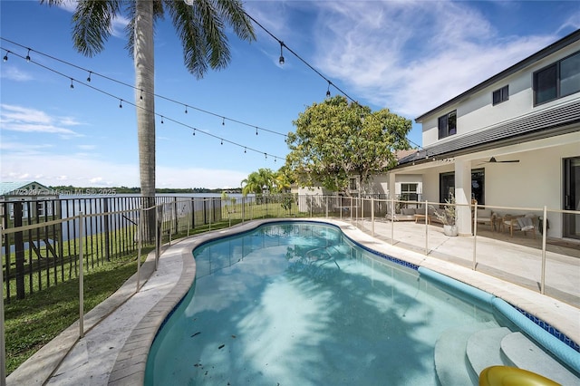 view of swimming pool featuring ceiling fan and a patio