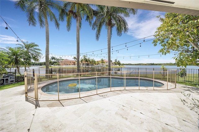 view of swimming pool with a water view and a patio area