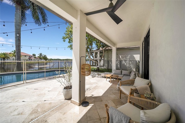 view of patio / terrace with ceiling fan, a fenced in pool, and an outdoor living space