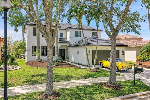 view of front of home featuring a front lawn and a garage