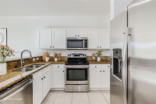 kitchen with sink, white cabinetry, appliances with stainless steel finishes, and dark stone counters