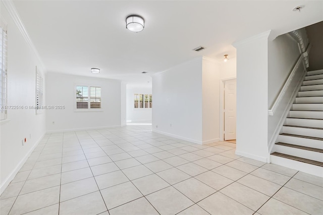 unfurnished room with crown molding and light tile patterned flooring