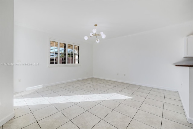 tiled empty room featuring ornamental molding and an inviting chandelier