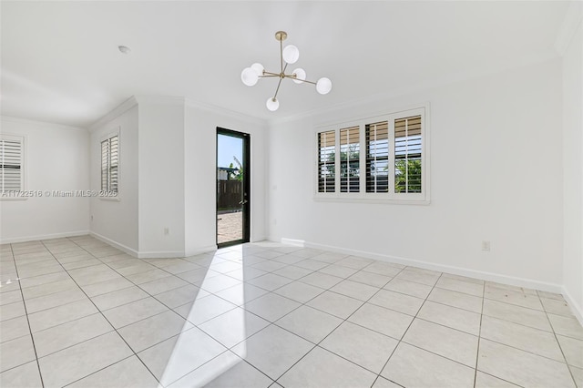 tiled spare room featuring crown molding, plenty of natural light, and an inviting chandelier