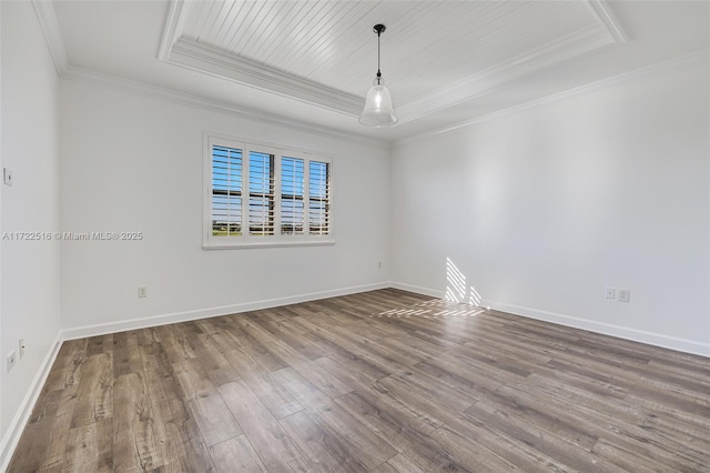 unfurnished room with crown molding, hardwood / wood-style floors, and a raised ceiling