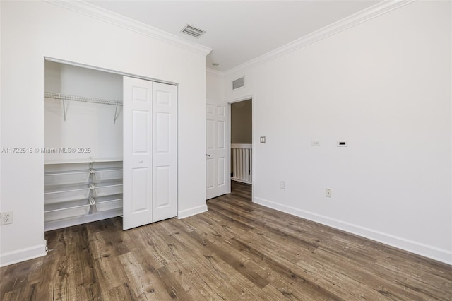 unfurnished bedroom with dark wood-type flooring and ornamental molding