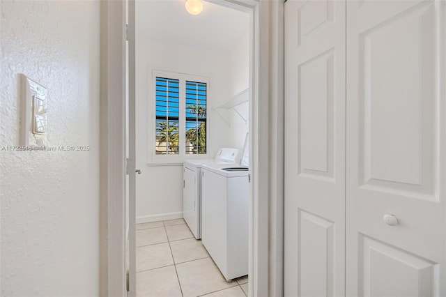 laundry room featuring light tile patterned floors and washing machine and clothes dryer