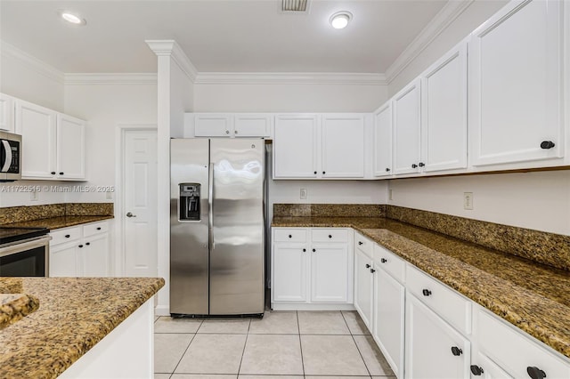 kitchen with white cabinets, dark stone counters, and appliances with stainless steel finishes