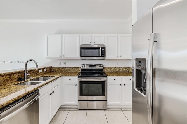 kitchen with white cabinets, dark stone countertops, appliances with stainless steel finishes, and sink