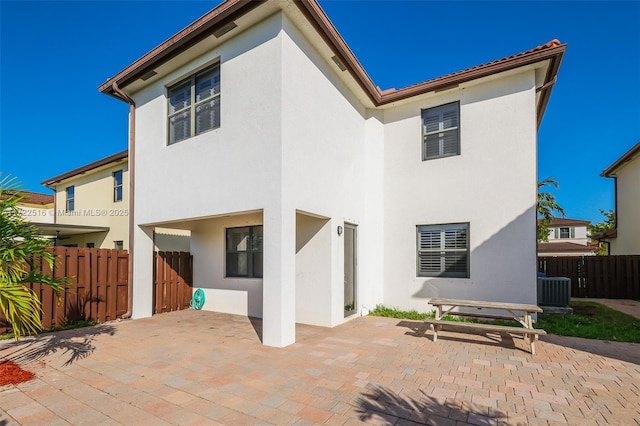 back of property with a patio