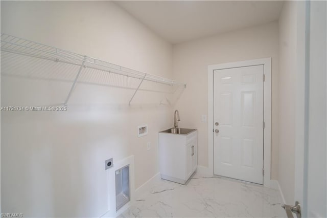 laundry area featuring hookup for a washing machine, light marble finish floors, hookup for an electric dryer, baseboards, and cabinet space