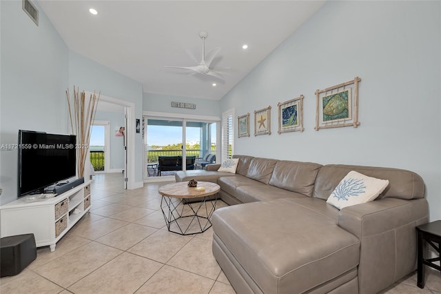 tiled living room featuring ceiling fan and lofted ceiling