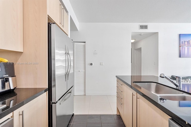 79 SW 12th St Unit 3809S, Miami, FL 33130 - kitchen featuring freestanding refrigerator, dark tile patterned flooring, and light brown cabinetry