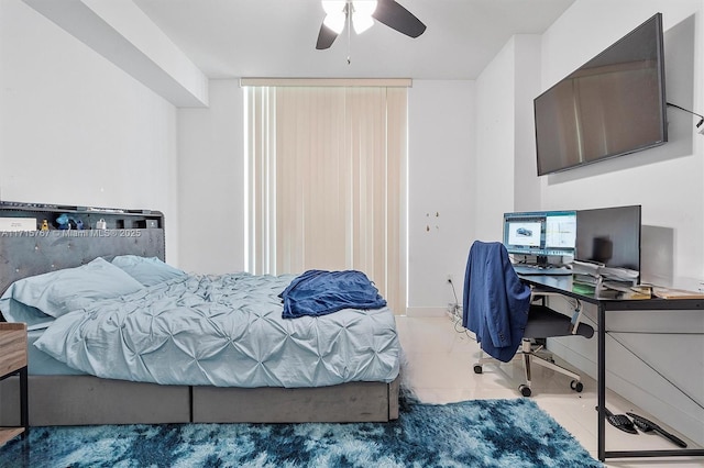 tiled bedroom featuring ceiling fan