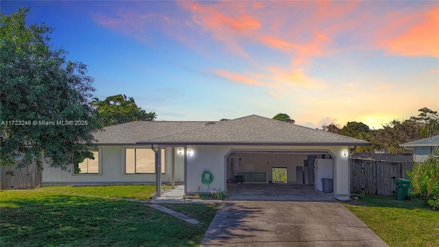 ranch-style house featuring a lawn and a garage