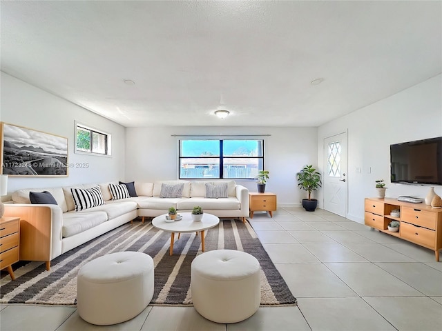 living room featuring a wealth of natural light and light tile patterned floors