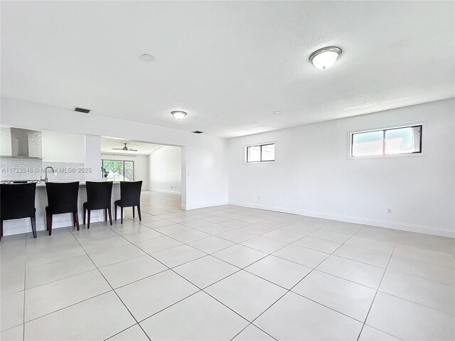 tiled living room with high vaulted ceiling