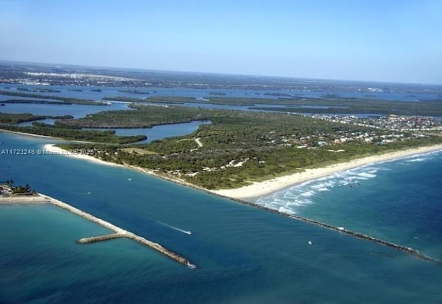 bird's eye view featuring a water view and a view of the beach