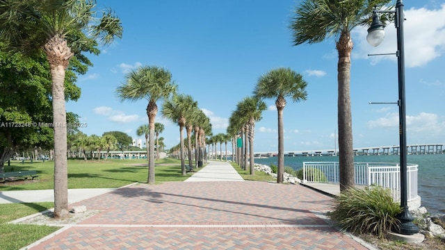 view of community with a water view and a yard