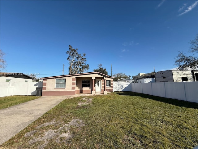 back of property featuring a lawn and a porch