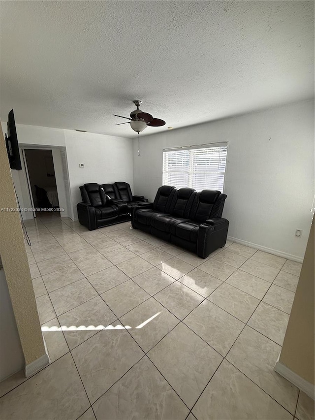 living room featuring ceiling fan and light tile patterned floors