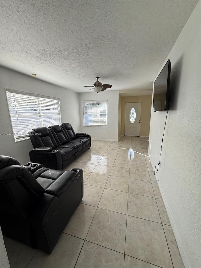 tiled living room featuring a textured ceiling and ceiling fan