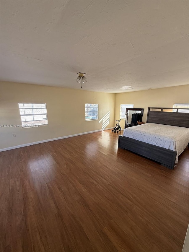 unfurnished bedroom with dark wood-type flooring