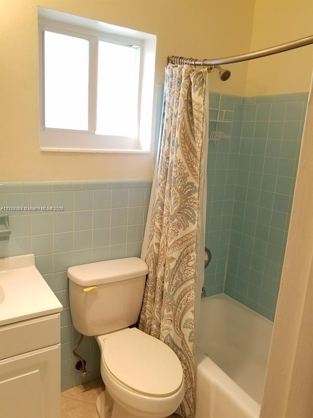 full bathroom featuring vanity, shower / bathtub combination with curtain, tile walls, tile patterned flooring, and toilet